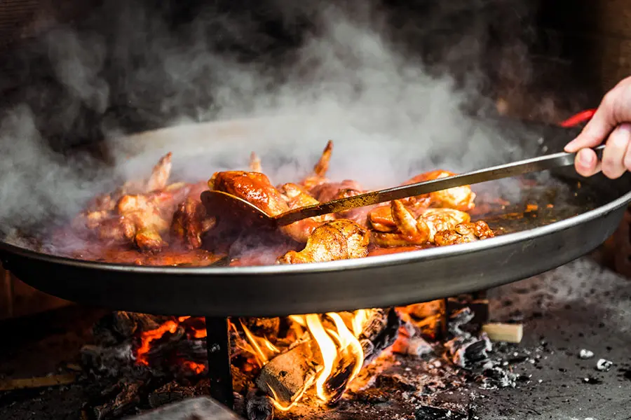 Grilling chicken on an open fire
