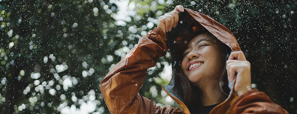 Woman protecting her hair against the rain