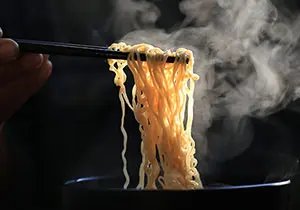 Eating noodles with chopsticks