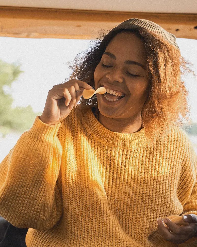 Woman eating crisps