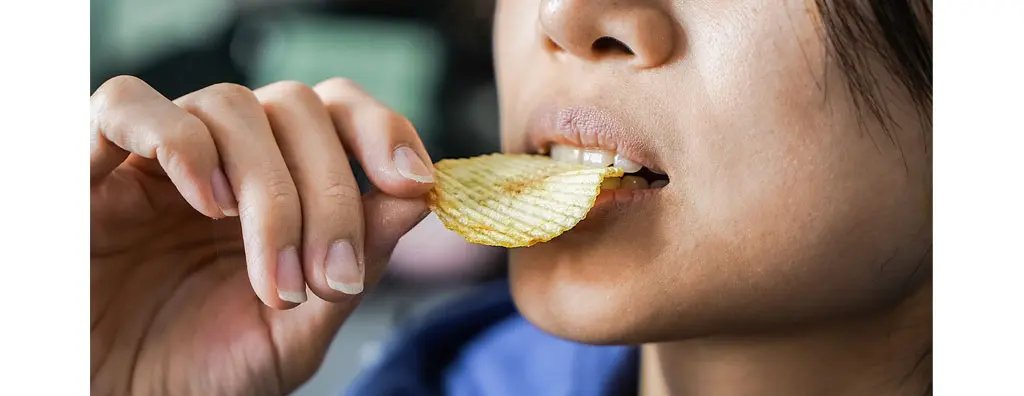 Woman eating a crisp