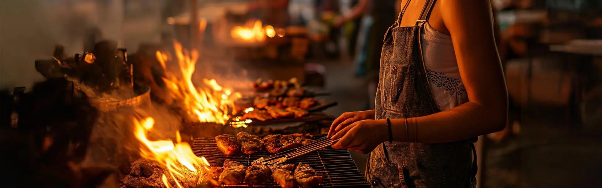 Young woman grilling meat on a barbecue